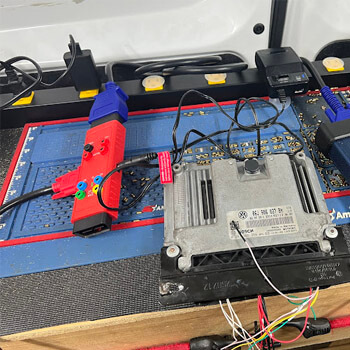 Vehicle ECU reflashing on workbench by Defense Locksmith Buffalo NY
