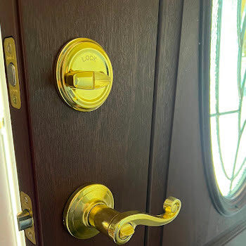 Brass lever lockset installation on a Buffalo NY home