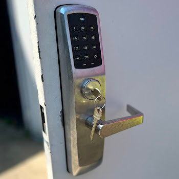 Keypad smart lock installation on a residential door by Defense Locksmith Buffalo NY