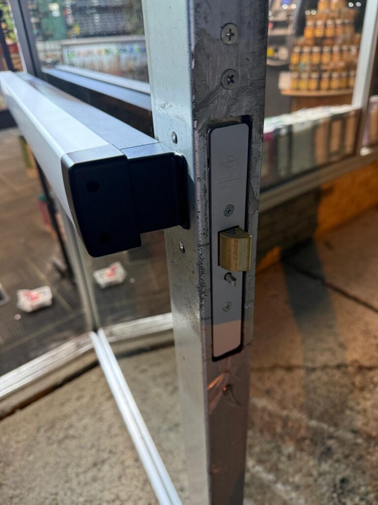 Commercial access control keypad installed on a glass door in the Buffalo Metro area