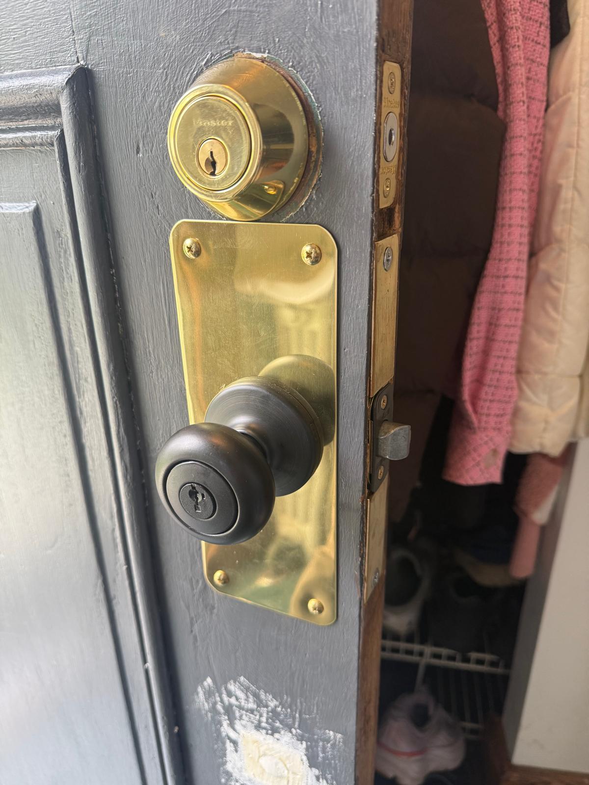 Deadbolt service on a Buffalo, NY entry door Brass deadbolt and handle on an exterior door serviced by a Buffalo, NY locksmith