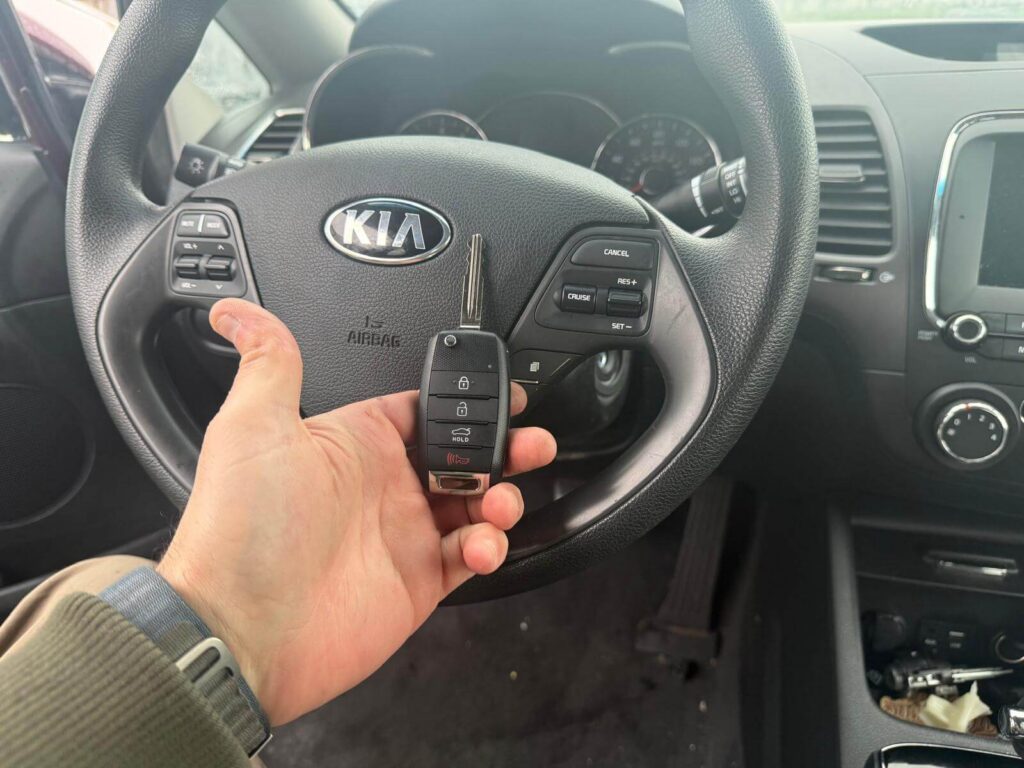 Kia replacement key fob held inside the vehicle in the Buffalo Metro area