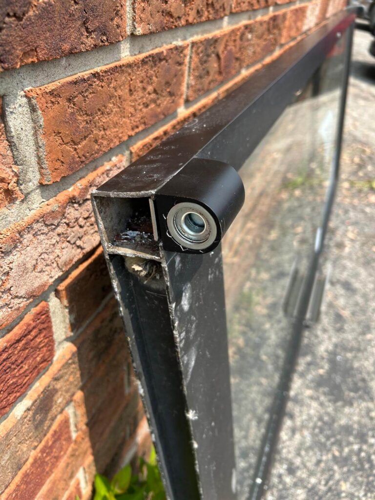 Commercial door closer mounted on a metal storefront frame at a Buffalo, NY business