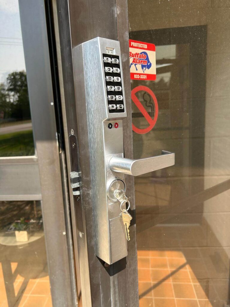 Mechanical pushbutton keypad lock with lever handle on a commercial glass door in Buffalo, NY
