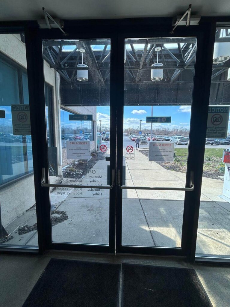 Commercial double storefront doors with push bars and door closers in Buffalo, NY