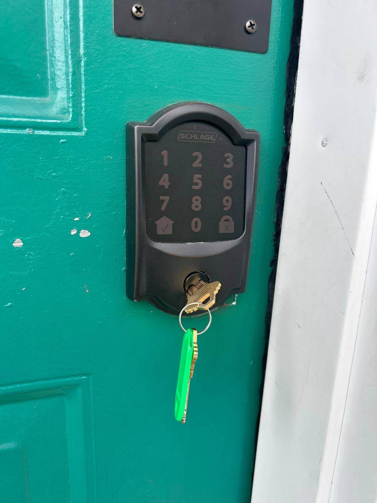 Keypad deadbolt installed on a service door in Buffalo, NY Schlage keypad deadbolt installed on a green exterior service door in Buffalo, NY