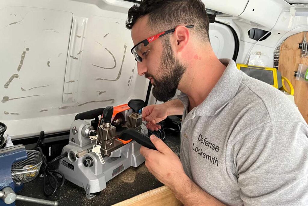 Locksmith working on a key at a mobile workbench
