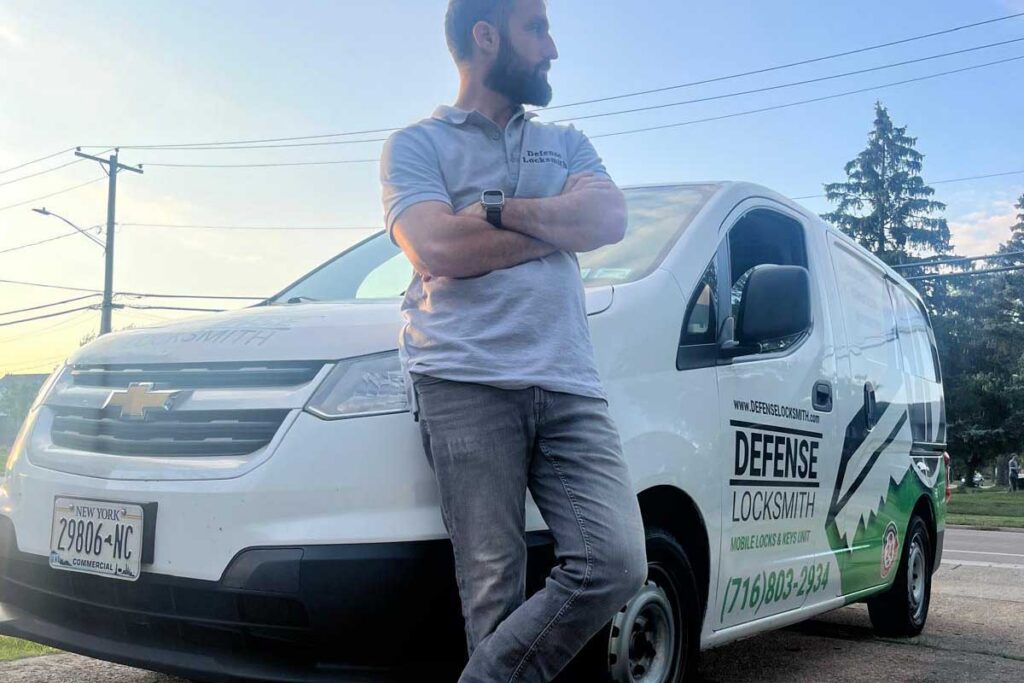 Defense Locksmith technician beside a mobile locksmith service van