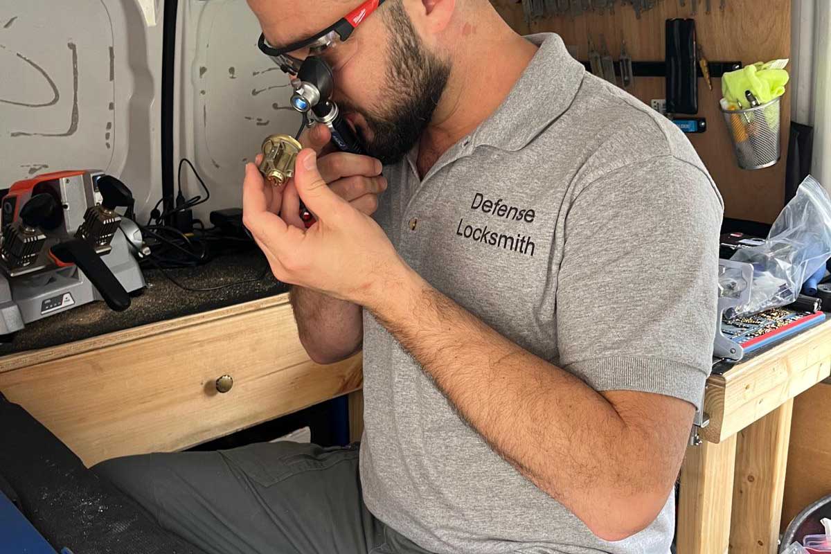 Mobile locksmith key cutting service in Buffalo, NY Defense Locksmith technician cutting a key on-site in Buffalo, NY