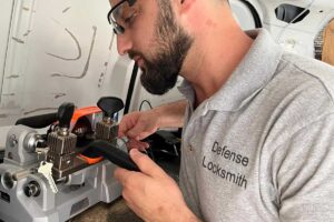 Locksmith technician cutting a programmed car key