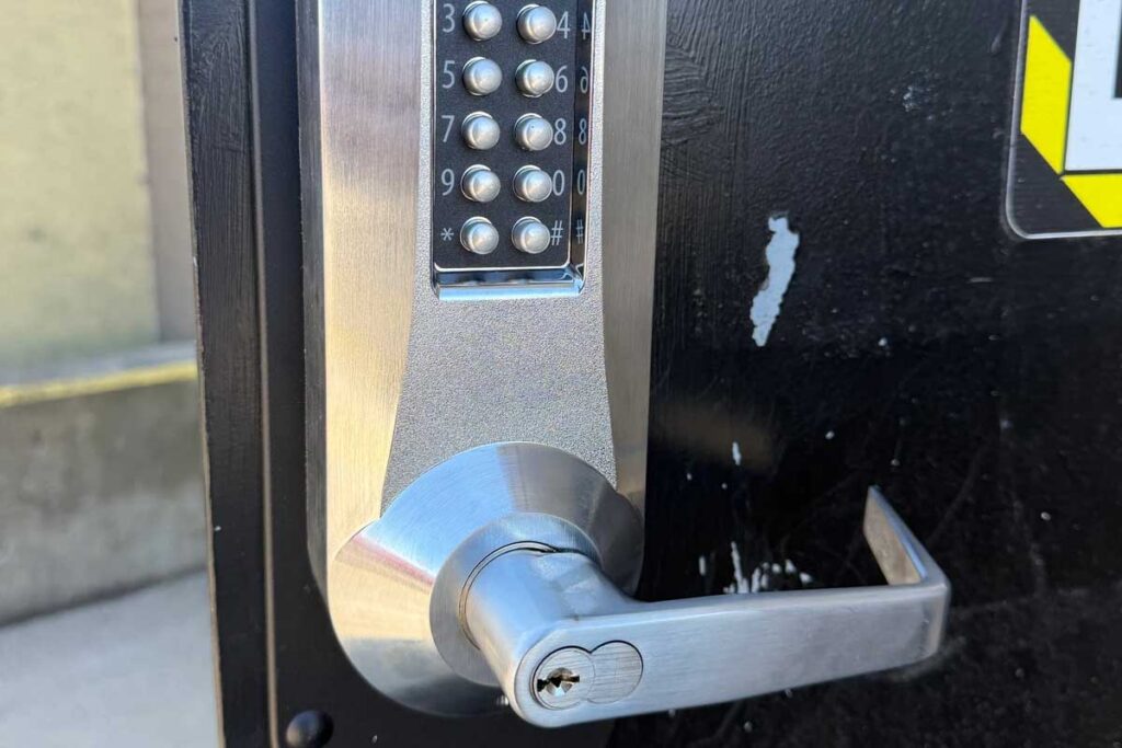 mechanical keypad door lock installed on a commercial entry door
