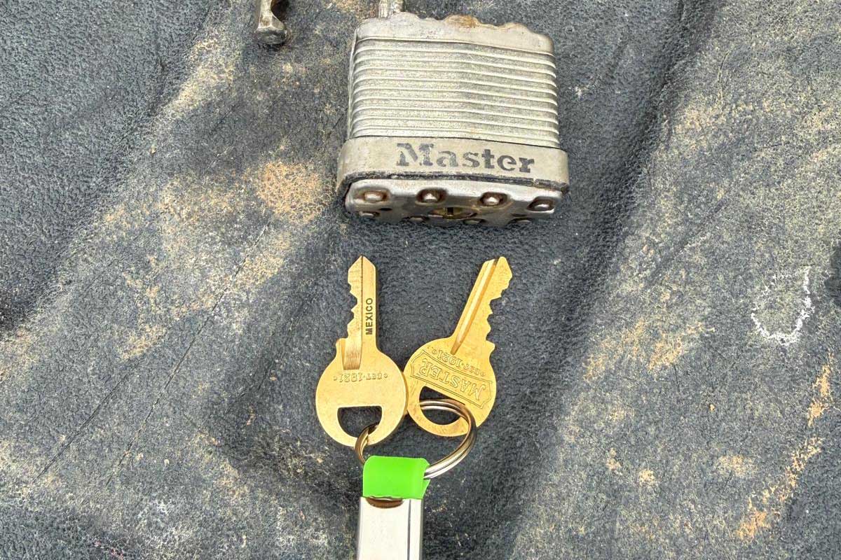 Padlock and keys serviced in Buffalo, NY Padlock with a set of keys and a green Defense Locksmith tag in Buffalo, NY
