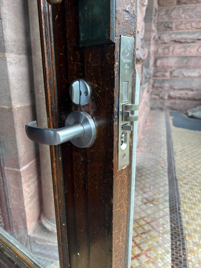 Storefront lever handle lock and deadbolt on a wood commercial door in Buffalo, NY