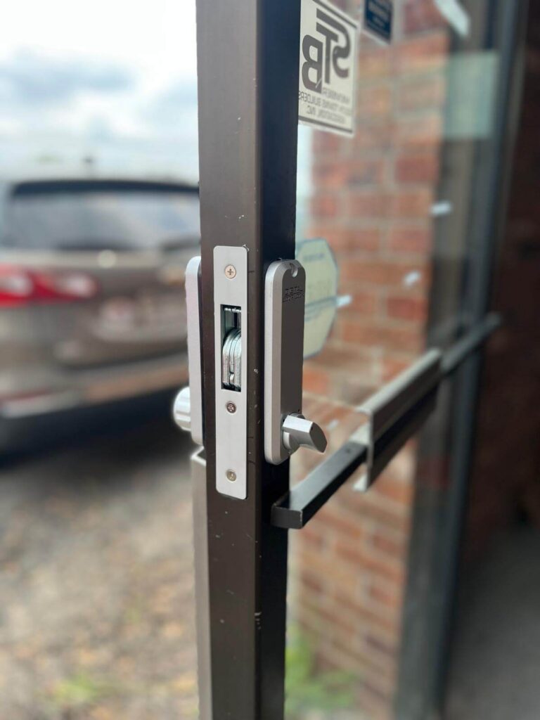 Storefront mortise lock and lever handle on a commercial glass door in Buffalo, NY