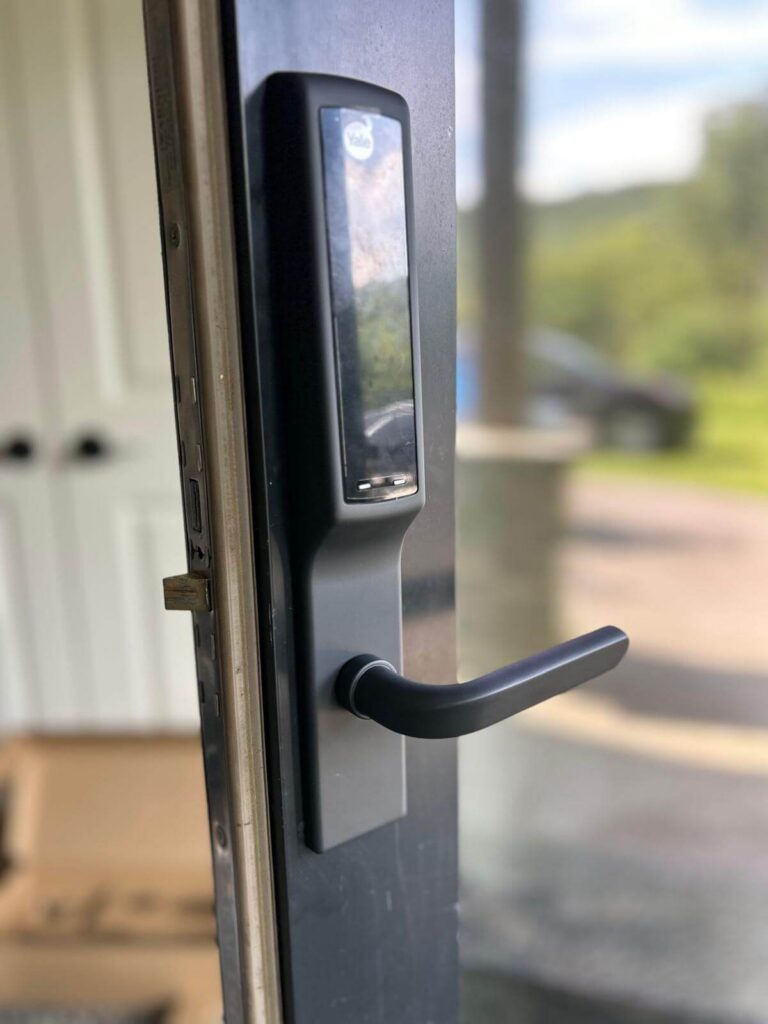 Yale electronic smart lock and lever handle on a storefront glass door in Buffalo, NY