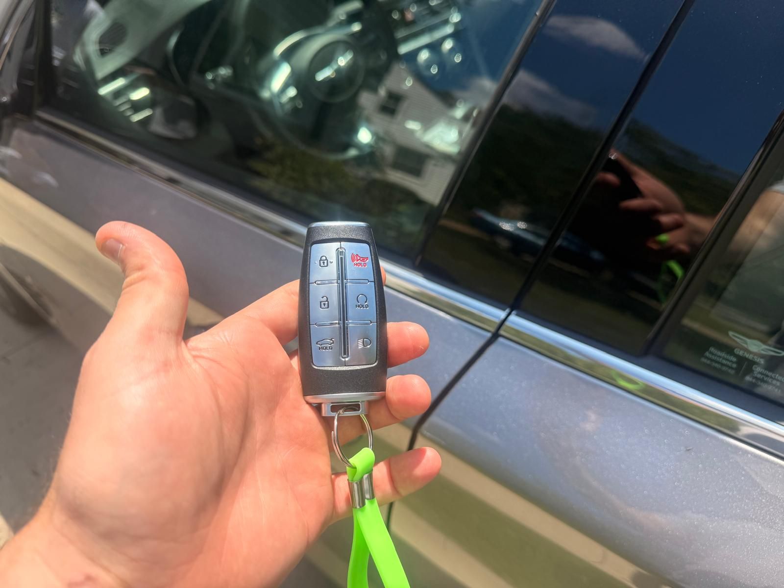 Genesis G70 key fob programmed on-site in Buffalo, NY New Genesis G70 proximity key fob held beside the car door after on-site programming