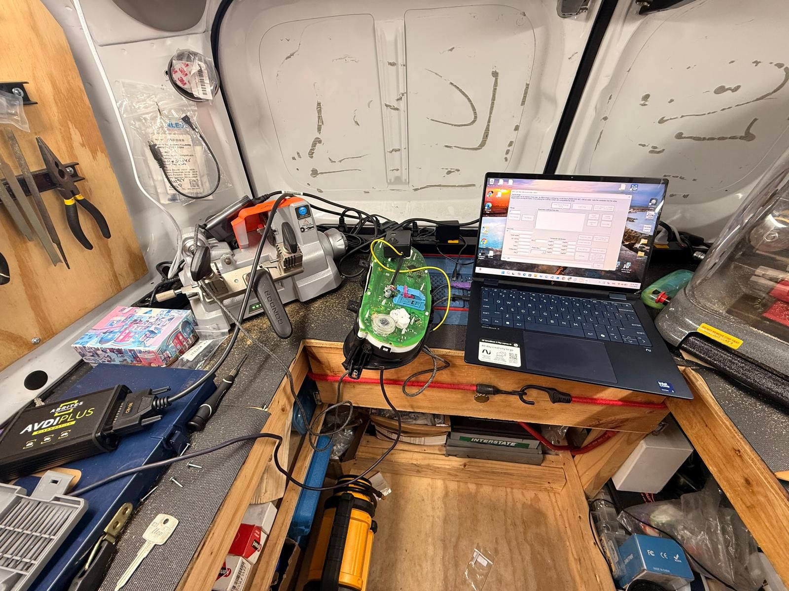2016 VW Jetta EEPROM key programming in Buffalo, NY Volkswagen Jetta immobilizer module opened with jumper wires soldered to the board, next to a laptop and diagnostic interface